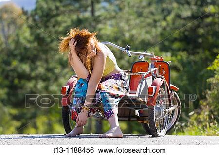Young woman - troubles with a flat tire View Large Photo Image Stock Photograph - Young woman - troubles with a flat tire. Fotosearch