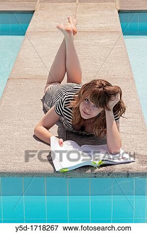 young woman trying to study Economics at the swimming pool View Large Photo Image Stock Photo - young woman trying to study Economics at the swimming pool. Fotosearch