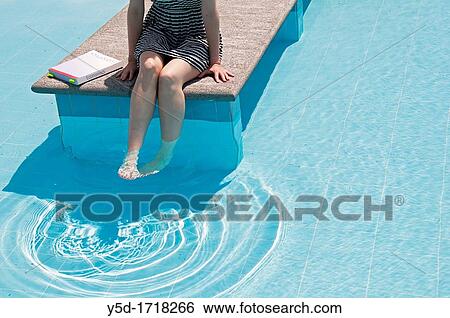 young woman trying to study Economics at the swimming pool View Large Photo Image Stock Photograph - young woman trying to study Economics at the swimming pool. Fotosearch