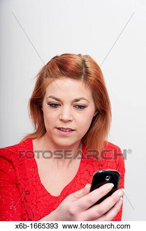 Young woman using a mobile phone View Large Photo Image Stock Image - Young woman using a mobile phone. Fotosearch