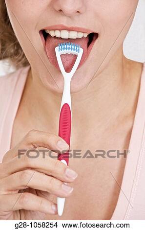 young woman using a tongue grater View Large Photo Image Picture - young woman using a tongue grater. Fotosearch