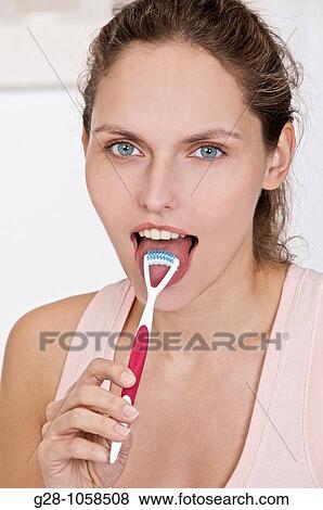 young woman using a tongue grater View Large Photo Image Stock Photo - young woman using a tongue grater. Fotosearch