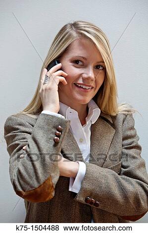 Young woman using cell phone View Large Photo Image Stock Photo - Young woman using cell phone. Fotosearch