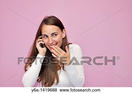 Young woman using cell phone View Large Photo Image Stock Photo - Young woman using cell phone. Fotosearch