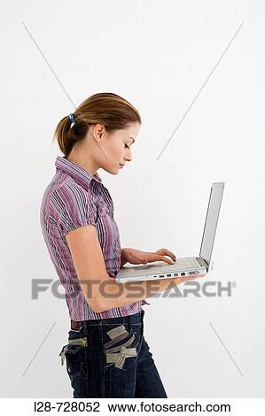 Stock Image - young woman using computer. Fotosearch