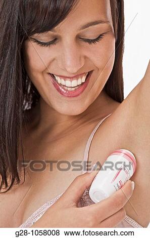 young woman using deodorant in her bathroom close up View Large Photo Image Stock Photo - young woman using deodorant in her bathroom close up. Fotosearch