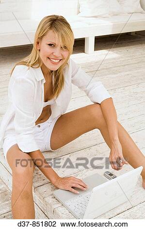 Young woman using her laptop happy View Large Photo Image Stock Image - Young woman using her laptop happy. Fotosearch