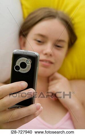 young woman using mobile phone View Large Photo Image Stock Image - young woman using mobile phone. Fotosearch