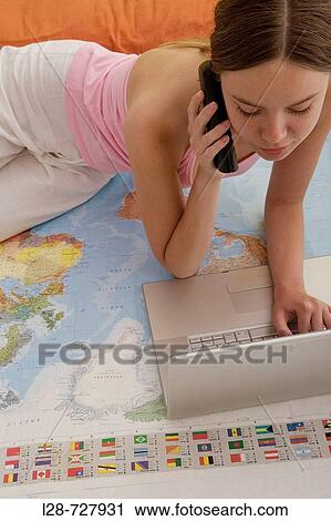 Young woman using phone, world map on the floor View Large Photo Image Stock Image - Young woman using phone, world map on the floor. Fotosearch