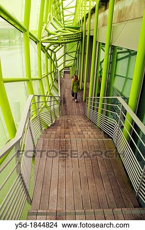 Picture - young woman walking down the stairs inside the Institut Francais de la Mode, Paris, France. Fotosearch