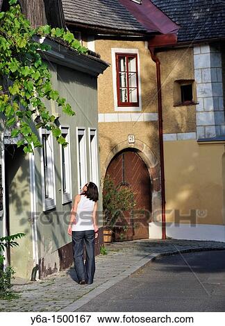 Young woman walking on sidewalk in Grinzing Vienna Austria View Large Photo Image Stock Photo - Young woman walking on sidewalk in Grinzing Vienna Austria. Fotosearch