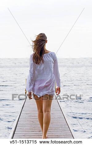Young woman walking untill the end of a pier View Large Photo Image Stock Photography - Young woman walking untill the end of a pier. Fotosearch