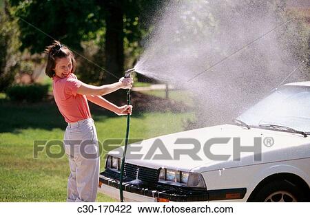 Young woman washing her automobile View Large Photo Image Stock Image - Young woman washing her automobile. Fotosearch