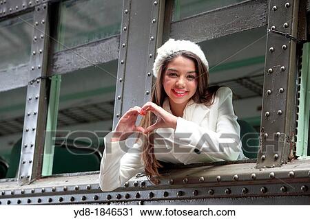 Stock Image - Young woman waving from one of the trains of the Gold Coast Railroad Museum, Miami, Florida, USA. Fotosearch