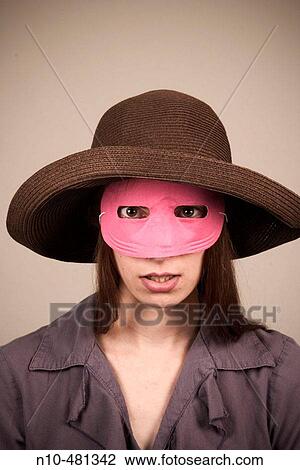 Young woman, wearing a hat and pink mask, posing View Large Photo Image Stock Image - Young woman, wearing a hat and pink mask, posing. Fotosearch