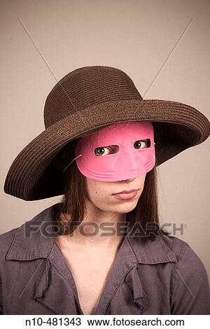 Young woman, wearing a hat and pink mask, posing View Large Photo Image Stock Image - Young woman, wearing a hat and pink mask, posing. Fotosearch