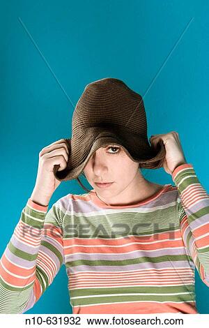 Stock Image - Young woman wearing a hat.. Fotosearch