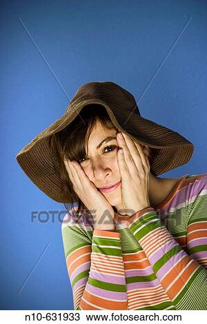 Stock Image - Young woman wearing a hat.. Fotosearch