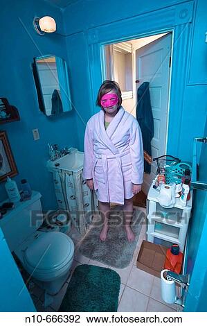 Young woman, wearing a pink mask, standing in her bathroom. View Large Photo Image Stock Image - Young woman, wearing a pink mask, standing in her bathroom.. Fotosearch
