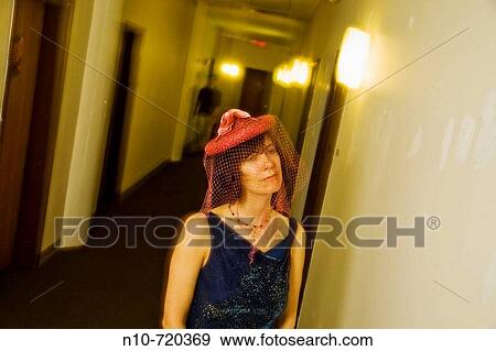 Young woman, wearing a red hat with a veil, standing in her apartment hallway. View Large Photo Image Stock Photo - Young woman, wearing a red hat with a veil, standing in her apartment hallway.. Fotosearch