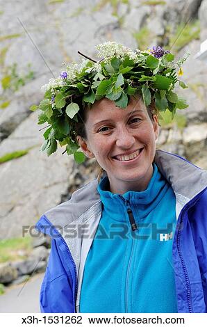 young woman wearing a wreath of leaves and flowers to celebrate summer solstice, Senja island, County of Troms, Norway, Northern Europe View Large Photo Image Stock Image - young woman wearing a wreath of leaves and flowers to celebrate summer solstice, Senja island, County of Troms, Norway, Northern Europe. Fotosearch