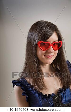 Young woman wearing heart shaped glasses View Large Photo Image Stock Image - Young woman wearing heart shaped glasses. Fotosearch