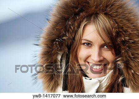 Young woman wearing hood View Large Photo Image Stock Photo - Young woman wearing hood. Fotosearch