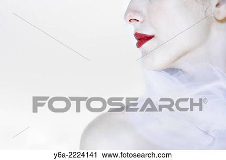 Stock Image - Young woman wearing red lipstick, close-up.. Fotosearch