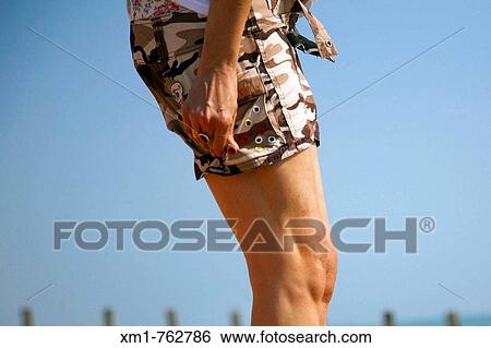 Young woman wearing shorts on the beach View Large Photo Image Stock Photograph - Young woman wearing shorts on the beach. Fotosearch
