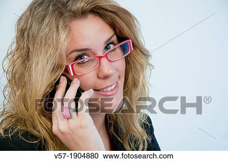 Young woman wearing spectacles, looking at the camera and using mobile phone. Close view. View Large Photo Image Stock Image - Young woman wearing spectacles, looking at the camera and using mobile phone. Close view.. Fotosearch