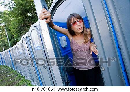 Young woman, wearing sunglasses, inside a portable toilet View Large Photo Image Stock Image - Young woman, wearing sunglasses, inside a portable toilet. Fotosearch