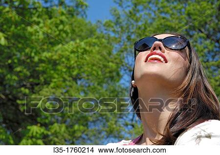 Young woman wearing sunglasses View Large Photo Image Picture - Young woman wearing sunglasses. Fotosearch