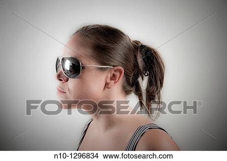 Picture - Young woman wearing sunglasses. Fotosearch