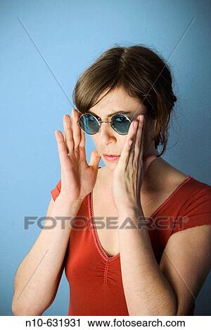 Young woman wearing sunglasses. View Large Photo Image Stock Image - Young woman wearing sunglasses.. Fotosearch