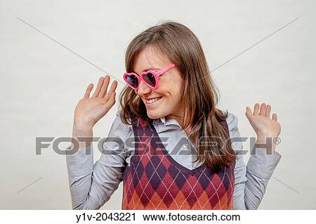 Stock Image - Young woman wearing sunglasses.. Fotosearch