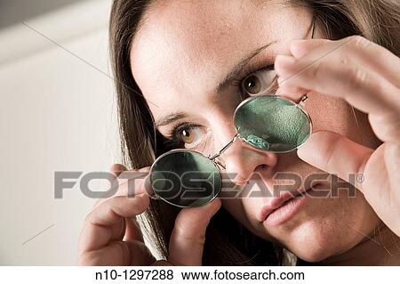 Stock Photo - Young woman wearing sunglasses. Fotosearch