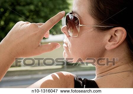 Young woman wearing sunglasses View Large Photo Image Stock Photo - Young woman wearing sunglasses. Fotosearch