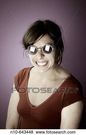 Young woman wearing sunglasses. View Large Photo Image Stock Photo - Young woman wearing sunglasses.. Fotosearch