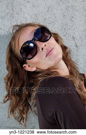 young woman wearing sunglasses View Large Photo Image Stock Photo - young woman wearing sunglasses. Fotosearch
