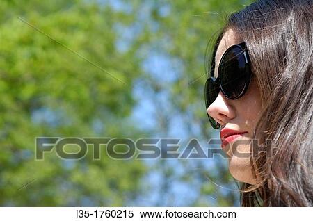 Young woman wearing sunglasses View Large Photo Image Stock Photography - Young woman wearing sunglasses. Fotosearch