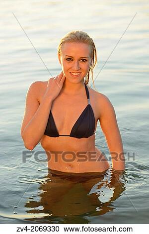 Young woman with a bikini bathing in a lake in Austria. View Large Photo Image Stock Image - Young woman with a bikini bathing in a lake in Austria.. Fotosearch
