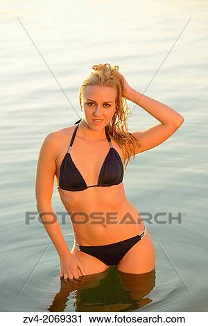 Young woman with a bikini bathing in a lake in Austria. View Large Photo Image Stock Image - Young woman with a bikini bathing in a lake in Austria.. Fotosearch