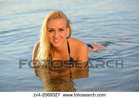 Young woman with a bikini bathing in a lake in Austria. View Large Photo Image Stock Photo - Young woman with a bikini bathing in a lake in Austria.. Fotosearch