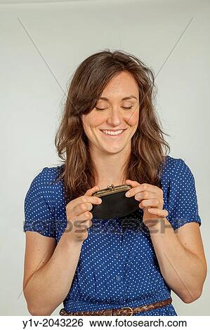 Stock Photograph - Young woman with a coin purse.. Fotosearch