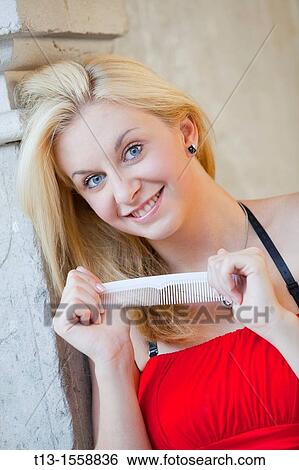 Young woman with a hair-brush in hands View Large Photo Image Stock Photograph - Young woman with a hair-brush in hands. Fotosearch