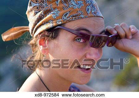 young woman with a headscarf and sunglasses View Large Photo Image Picture - young woman with a headscarf and sunglasses. Fotosearch