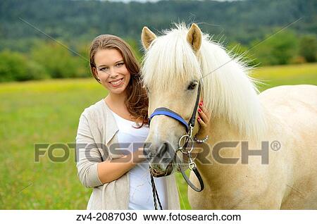Young woman with a Icelandic horse on a meadow, Germany. View Large Photo Image Stock Image - Young woman with a Icelandic horse on a meadow, Germany.. Fotosearch