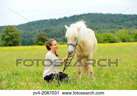 Young woman with a Icelandic horse on a meadow, Germany. View Large Photo Image Stock Image - Young woman with a Icelandic horse on a meadow, Germany.. Fotosearch