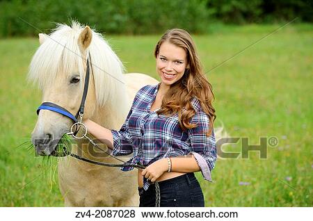 Young woman with a Icelandic horse on a meadow, Germany. View Large Photo Image Stock Photo - Young woman with a Icelandic horse on a meadow, Germany.. Fotosearch