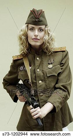 Picture - Young woman with a Kalashnikov and wearing Russian soldier's clothes. Fotosearch